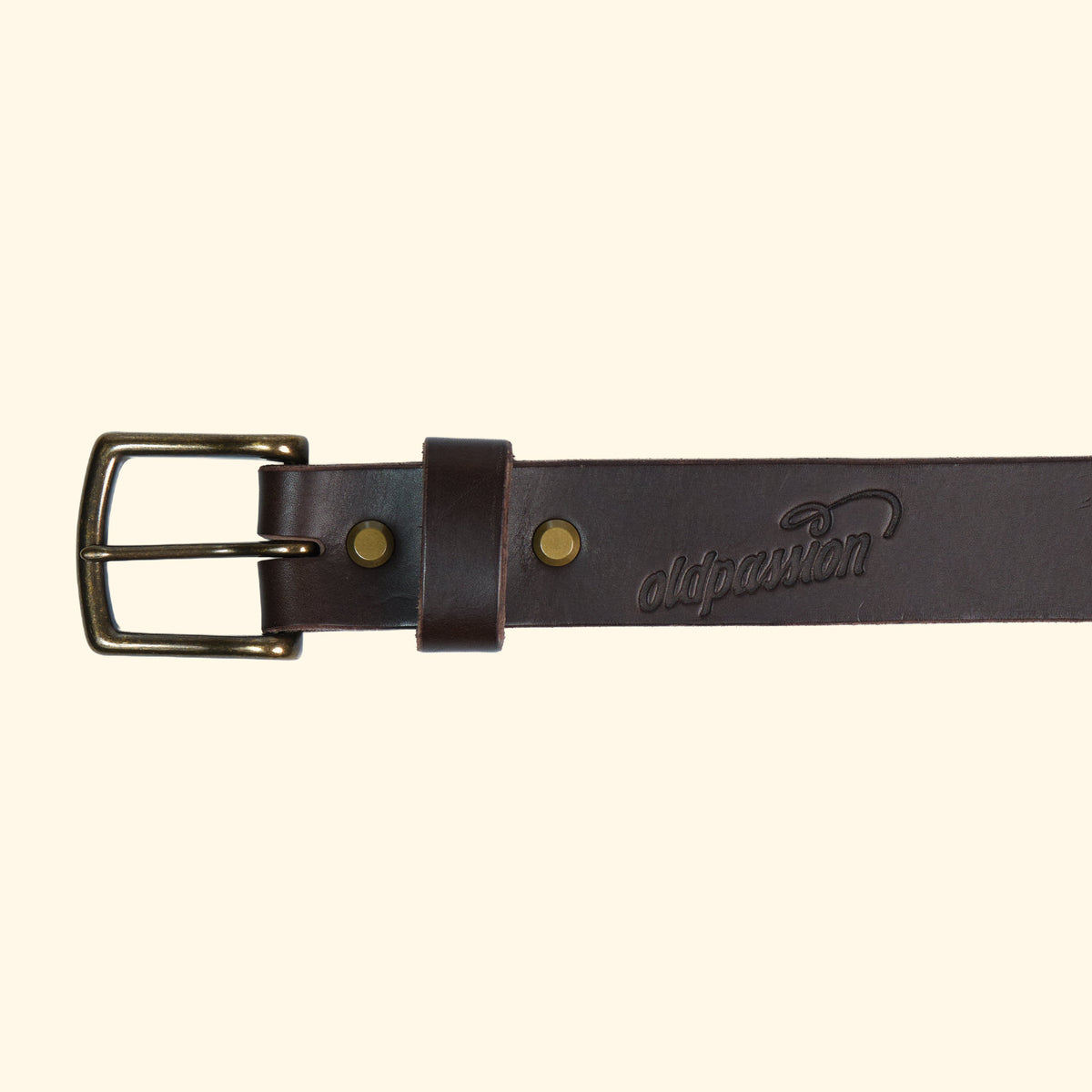Detailansicht des op belt in Rocky Dark Brown mit antik-farbener Schnalle, feiner Logoprägung und glatter, dunkler Lederstruktur.